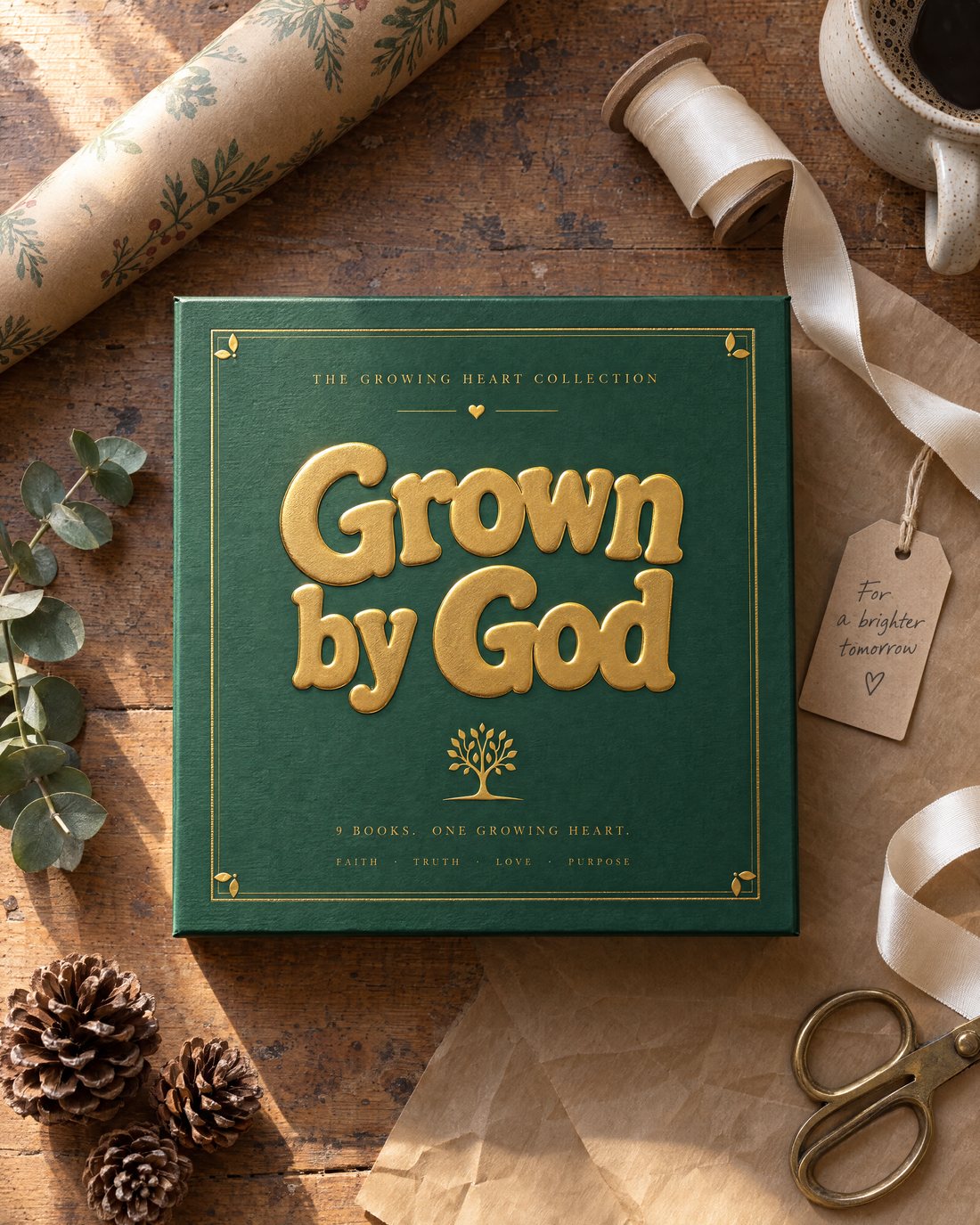 The green slipcase with raised gold-foil lettering on an oak table beside kraft paper, ribbon and a gift tag